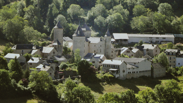 Saint Saturnin de Tartaronne and its 13th-century château. It lies at the foot of the Causse de Sauveterre cliffs, 3 km from Banassac in the Lot Valley.