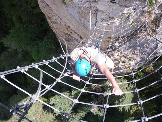 Via Ferrata de Roqueprins overlooking La Canourgue. Optional course with net;