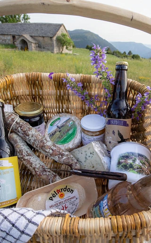 Basket of local products, cheese, charcuterie, jam and beer
