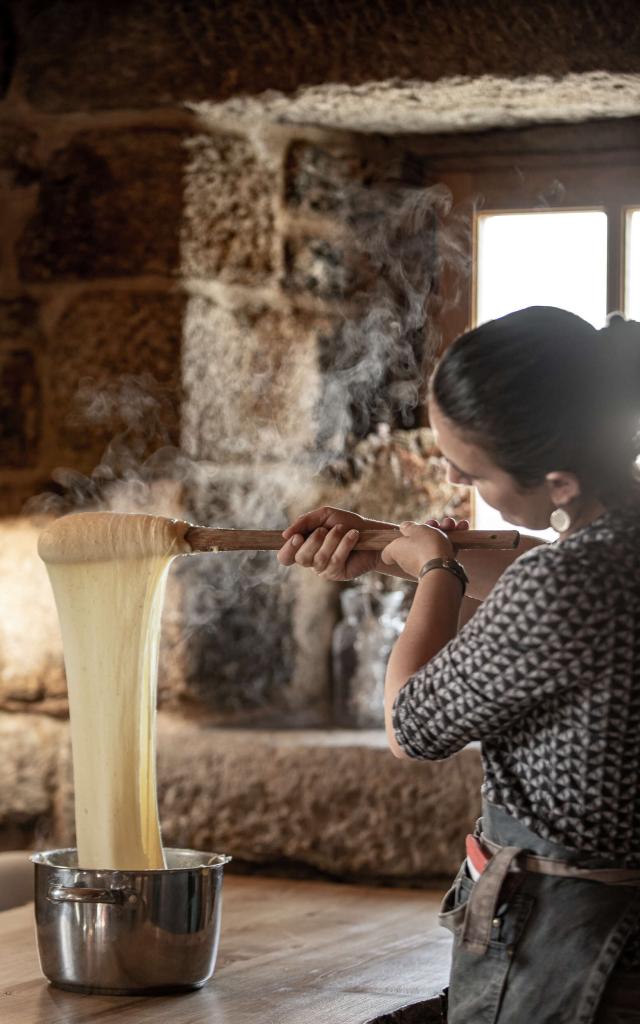 Woman preparing aligot in an Aubrac buron.