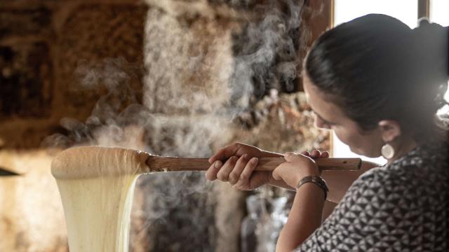 Woman preparing aligot in an Aubrac buron.